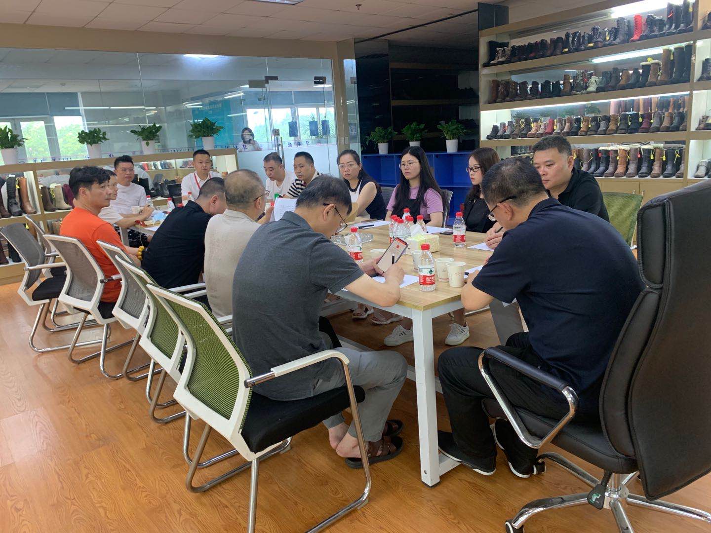 Product discussion around the footwear showroom table