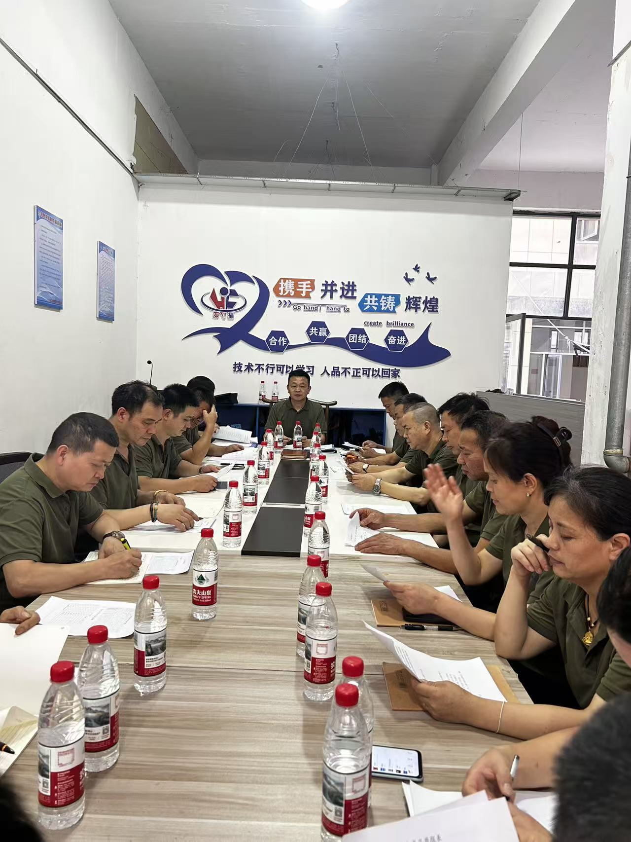 Team meeting at the SHI JI footwear factory